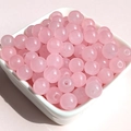 Macro shot of 8mm pink translucent glass beads in a tray for DIY jewelry making - 8mm / Pink