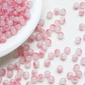Macro shot of 8mm pink and white gradient glass beads with a smooth polished finish - Nutmeg Color (A14)