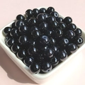 Close-up of 8mm polished black glass beads for DIY jewelry making in a white ceramic bowl - 8mm / Black