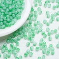 Macro shot of 6mm translucent light green gradient jade-like glass beads for DIY jewelry - Emerald Green (A20)