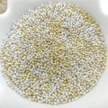 Close-up of gold and silver metallic round spacer beads in a white ceramic bowl - 100pcs/Pack (P22#) / 3.2mm / Gold & Silver Mix