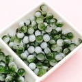 Detail of green and white marble pattern glass beads in a white sorting tray for DIY jewelry - Semi-White Dark Green Crackle (E41#)