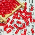 Close-up of red drum-shaped glass beads on bamboo tray for DIY jewelry making crafts - Bright Red Bamboo Tube (6x12mm-J14#)