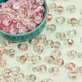 Macro view of 8-10mm Christmas glass beads with red and white patterns for DIY crafts - Transparent Drifting Red (A361#)
