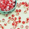 Macro shot of red and white crackle glass beads for DIY jewelry making in a ceramic bowl - Crackled Red (B3#)