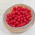 Close-up of translucent red glass beads for DIY jewelry making in a stone bowl - 4mm / Agate Red