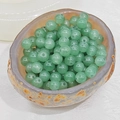 Macro shot of polished green aventurine round beads in a natural stone bowl - 8mm (1.6mm Hole) / Verdant