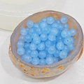 Macro shot of transparent light blue glass beads with pre-drilled holes in a stone bowl - 10mm / Aqua
