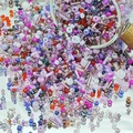 Colorful mix of DIY glass beads and bugle beads spilling from a jar for jewelry making - Dusty Rose Purple (M751)