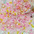 Dynamic close-up of mixed pink and yellow DIY glass beads pouring from a glass container - Yellow Pink (M755)