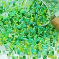 Close-up of mixed green glass seed beads and bugle beads for DIY jewelry making - Green (M757)