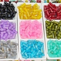 Close-up of bamboo-shaped glass beads with golden brushed texture in various colors - J50 Random Mixed Brushed Jade Style Bamboo