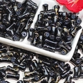 Macro view of black glass bamboo-style beads with gold textures in a white tray - J52 Brushed Jade Style Bamboo Black