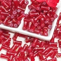 Macro view of 12x6mm bamboo-shaped red glass beads with gold wire drawing texture for DIY - J53 Brushed Jade Style Bamboo Red