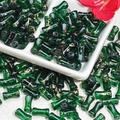 Macro view of dark green bamboo joint glass beads with golden silk marble texture - J78 Brushed Transparent Bamboo Forest Green