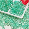 Macro shot of 12x6mm bamboo-style green glass beads with gold texture for DIY jewelry - J80 Brushed Transparent Bamboo Teal