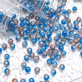 Macro detail of 10mm blue and bronze crackle glass beads spilling from glass jars - Silver Wire Crackle Style (H290) / 10mm / Blue Moon