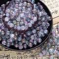 Detailed macro view of 10mm purple and blue ice-cracked glass beads with gold leaf patterns - Two-Tone Crackle Style (H205) / 8mm / Pale Blue