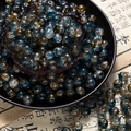 Macro detail of 10mm blue and amber glass beads with starburst texture for DIY jewelry - Two-Tone Crackle Style (H208) / 8mm / Dunhuang Style