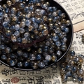 Macro detail of 10mm blue and gold crackle glass beads for DIY jewelry making - Two-Tone Crackle Style (H233) / 10mm / Firmament