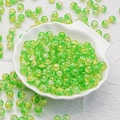Detailed view of 10mm yellow-green cracked glass beads in a white shell dish for DIY - Yellow Green Style(H17)