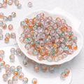 Macro shot of 10mm colorful cracked glass beads for DIY jewelry making in a shell tray - Purple Blue Gold (H76)