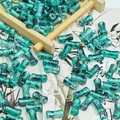 Macro view of green bamboo-shaped ceramic beads with ink wash patterns and gold flecks - Ink Wash Bamboo Ink Cyan Blue (J223# 6x12mm)