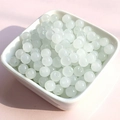 Pale green translucent 8mm glass beads for DIY jewelry making in a white ceramic bowl - 10mm / White