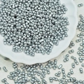 Macro view of matte silver 2-hole peanut spacer beads for handmade jewelry design - Silver