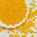 Macro detail of yellow twin-hole peanut beads for DIY jewelry and necklaces - Orange