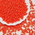 Macro shot of 3x6mm orange glass peanut beads with double holes for jewelry making - Orange Red