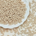 Detailed view of beige dumbbell-shaped dual-hole glass beads for DIY jewelry making - Beige