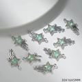 Detailed close-up of shiny star-shaped jewelry charms with pale green stones and rhinestones - Green Star Style (G162)