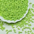 Macro detail of light green peanut-shaped glass beads for DIY jewelry making crafts - Light Green