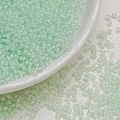 Macro view of 3mm light green translucent glass seed beads for DIY jewelry making - Green White (3mm)