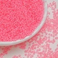 Macro shot of 3mm bright neon pink glass seed beads in a white bowl for DIY jewelry - Peony Pink (3mm)