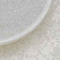 Macro shot of 3mm transparent glass seed beads on a white porcelain dish for jewelry DIY - 3mm / 10g/Pack / Clear