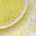 Macro shot of 3mm light yellow transparent glass seed beads with AB iridescent coating in a bowl - Lemon Yellow