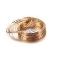 Macro detail of stacked gold memory wire coils for DIY jewelry making and bracelet crafting - 0.6mm Gauge 100 Loops/Pack/44g / KC Gold