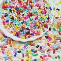 Mix of colorful 3x6mm peanut-shaped glass beads for DIY jewelry making in a white tray - 10g/Pack / Random Mixed Colors