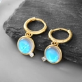 Golden earrings featuring a blue translucent moonstone pendant with small zircon accent - Opal