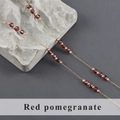 Detail of gold stainless steel chain with red garnet beads and golden accents - Garnet Style (C25505)