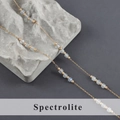 Macro detail of natural Spectrolite beads on a fine gold stainless steel jewelry chain - Spectrolite Style (C25506)