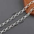 Close-up of 18k gold plated figure-8 chain links showing 9.9mm x 6.8mm dimensions - Bright Silver Engraved Rectangular Link Style (C25702)