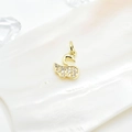 Elegant gold swan pendant with micro-pave crystals on a white shell background - Swan