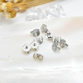 Silver plated butterfly earring backs on decorative shell with elegant floral accents - White Gold