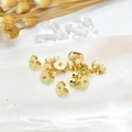 Polished 18k gold plated butterfly earring backs displayed on an elegant shell base - Gold