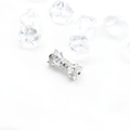 Macro shot of silver bow pendant with micro-pave cubic zirconia on ice cubes - Pink Zircon / White Gold