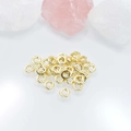 Golden open jump rings for DIY jewelry making displayed with natural quartz crystals - 6mm / Gold