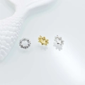Macro shot of silver and gold flower spacer beads with tiny zircon crystals for jewelry - 10x4x6mm